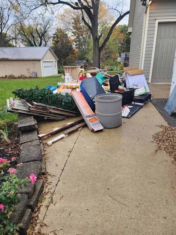 Dumpster being loaded with debris for Estate Cleanout Dumpster Rental in McCook